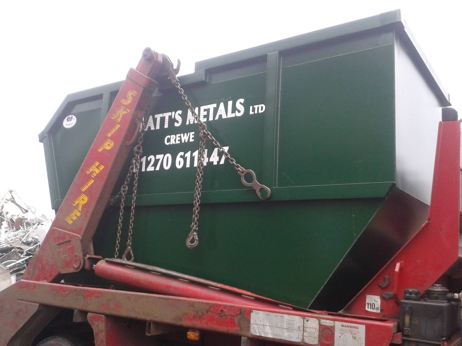 Skip lorry delivering a skip