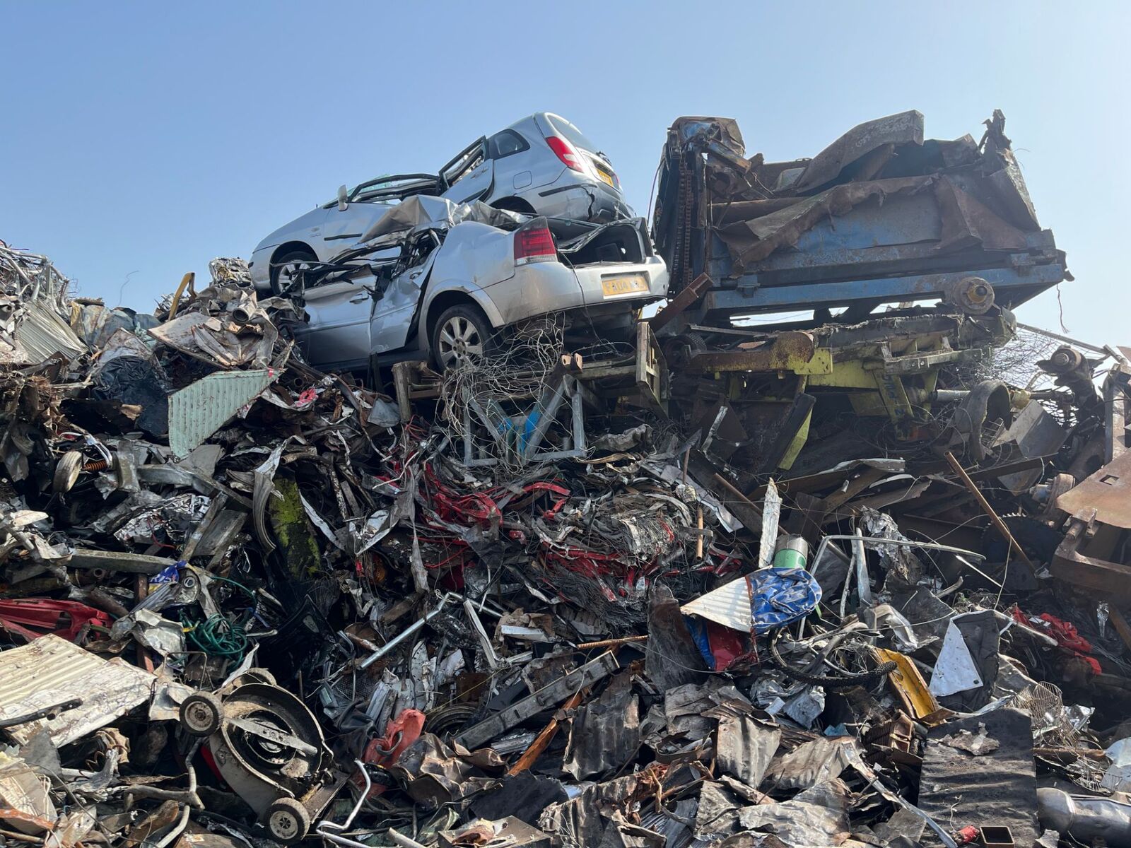 End-of-life vehicles stacked ready for processing