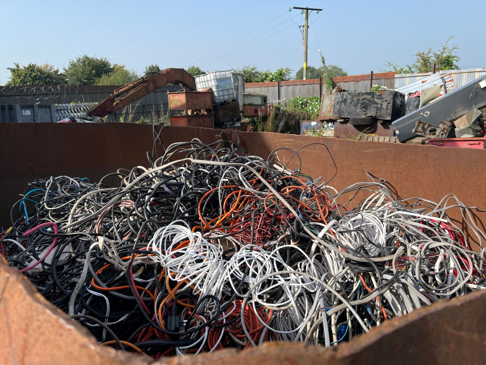 Container of coiled electrical cable ready for stripping